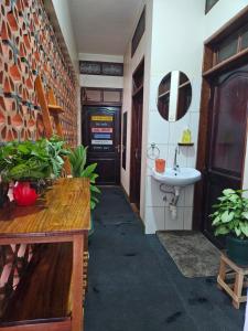 a room with a bathroom with a sink and a table at Aivilo Home in Entebbe +99 photos