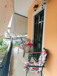 a balcony with a table and chairs on a balcony at Maira's place Corfu in Corfu