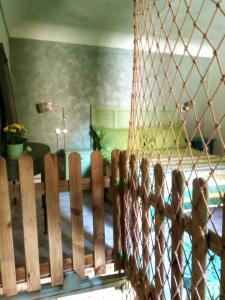a wooden fence in a room with a bed at Only for two Giumbabulla in Ragusa