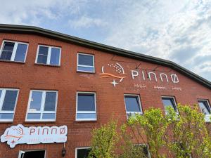 a brick building with graffiti on the side of it at Pinnø - Padel Hotel Food in Pinnow