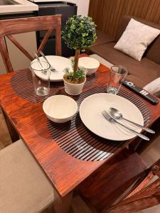 a wooden table with plates and utensils on it at Bunker in Baguio +2 photos