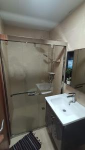 a bathroom with a shower and a sink at Bunker in Baguio