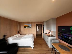 a hotel room with a bed and a kitchen at Kviltorp Camping in Molde