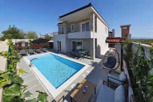 a house with a swimming pool on a balcony at Casa Coral in Zadar