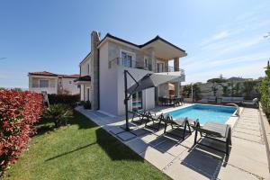 a villa with a swimming pool and a house at Casa Coral in Zadar