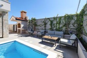 a patio with a pool and a table and chairs at Casa Coral in Zadar +41 photos