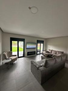 a living room with a couch and a tv at La jaima in Santa Ceclina