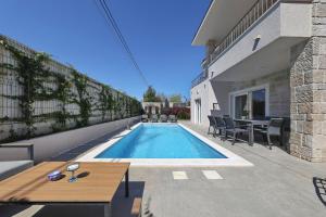 a swimming pool in the backyard of a house at Casa Coral in Zadar