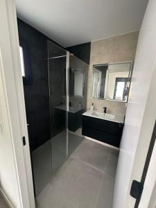 a bathroom with a glass shower and a sink at La jaima in Santa Ceclina +9 photos
