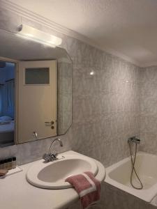 a bathroom with a sink and a tub and a mirror at Romantika in Platis Gialos +141 photos