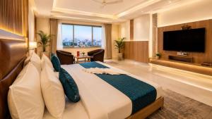 a hotel room with a large bed and a flat screen tv at Hotel Corporate Plaza Near Terminal 3 Delhi International Airport With Free Airport Pickup in New Delhi
