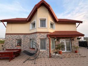 a house with a red roof and a picnic table at Nistor House-Delta Retreat in Tulcea +38 photos