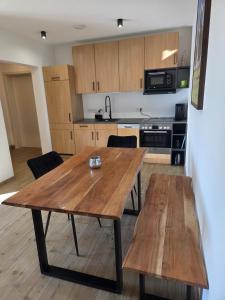 a kitchen with a wooden table in a room at RoSa Haus in Steingaden