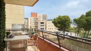 a balcony with a table and a view of a city at Salles Beach 33 in L'Estartit