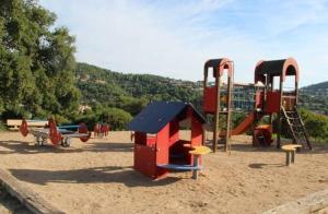 a playground with two play equipment in the sand at Location appartement proche Saint Tropez in Roquebrune-sur-Argens