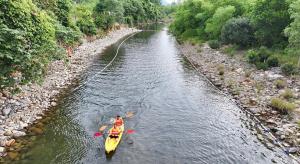 a person in a yellow kayak in a river at Lạc Sanh Onsen Resort in Tuy Hoa