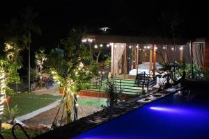 a house with a swimming pool at night at Old Village House in Yên Bài