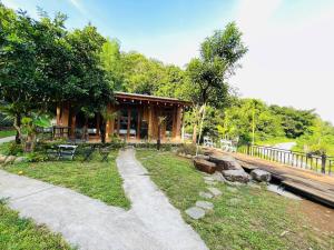 a log cabin with a path in front of it at Old Village House in Yên Bài