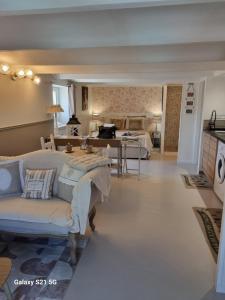 a living room with a couch and a bedroom at L'escapade des Cévennes in Rousson