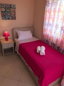 a bedroom with a bed with two towels on it at Theodora villas Portaria beach 2 in Paralia Dionysiou