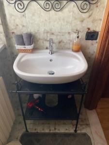 a white sink on a shelf in a bathroom at Bed & Breakfast Lujocanda in Casarza Ligure +28 photos