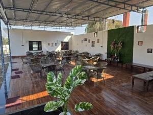 a room with tables and chairs in a building at Chill and Cheers Resort in Dehradun
