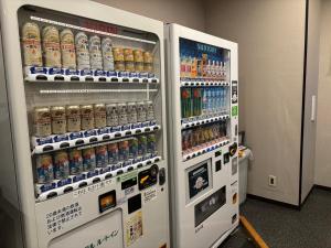 two soda vending machines in a room with drinks at Hotel Route-Inn Shibukawa in Shibukawa