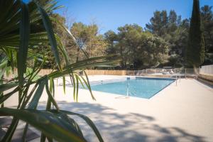 a swimming pool in a yard with a plant at Camping de la Vallée Heureuse in Orgon +77 photos