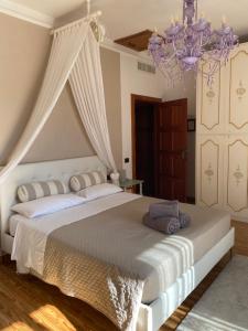a bedroom with a large bed with a chandelier at Bed & Breakfast Lujocanda in Casarza Ligure