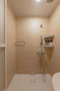 a shower with a glass door in a bathroom at Tenjin 旅音 in Kanazawa +32 photos