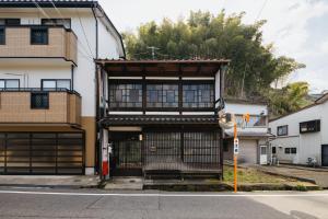 a building with an open door on a street at Tenjin 旅音 in Kanazawa