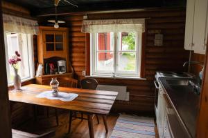a kitchen with a wooden table and a stove at Luthagård in Äng