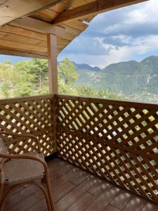 a balcony with a view of the mountains at Hillside Cottages, Kala Bagh in Nathia Gali