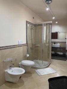 a bathroom with a shower and a toilet and a sink at B&B Il Cormorano in Scardovari