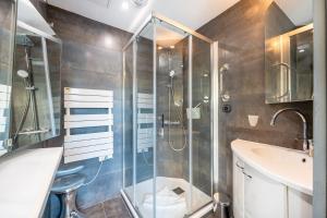 a bathroom with a shower and a toilet and a sink at Le Princess in Évian-les-Bains