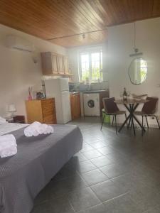 a room with a bed and a table and a kitchen at casa l'olivo in Forio d'Ischia
