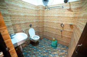 a bathroom with a toilet and a sink at Hotel Priyadarshini in Digha +21 photos