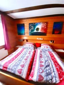 a bed with a red and white blanket on it at Ferienwohnung Angela in Thalfang