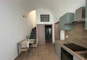 a kitchen and dining room with a table and chairs at Be Local-Avola stay in Avola