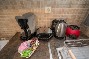 a kitchen counter with a coffee maker and a mixer at Nisaki Summer Stay Studios in Agia Ermioni