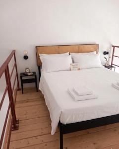 a bedroom with a large bed with white sheets at Be Local-Avola stay in Avola +8 photos