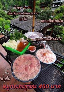 a bunch of food on a grill on a table at ป้าแมว โฮมสเตย์ in Ban Pok Nai