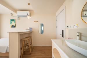 a bathroom with a sink and a tub and a counter at Shanghai WanTing Villa Hotel in Shanghai +98 photos