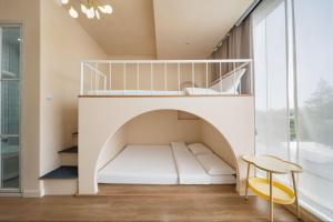 a room with a bunk bed and a stool at Shanghai WanTing Villa Hotel in Shanghai
