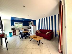 a living room with a red couch and a table at Campo Vecchio Dracena et Piscine in Ghisonaccia