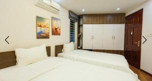 two beds sitting next to each other in a bedroom at Tara Hotel & Spa in Hanoi