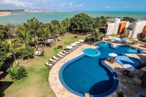 an aerial view of a resort swimming pool with the beach at Sun Bay Pipa Hotéis in Pipa
