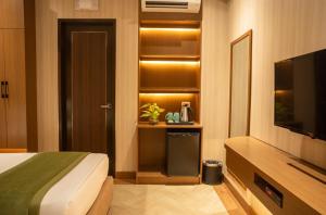 a hotel room with a bed and a television at Acuaverde Beach Resort in San Juan