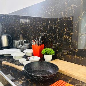 a kitchen counter with a frying pan and utensils at Revival Beach Resort in Hikkaduwa