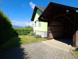 a building with a garage next to a house at Haus Luisi in Hitzendorf
